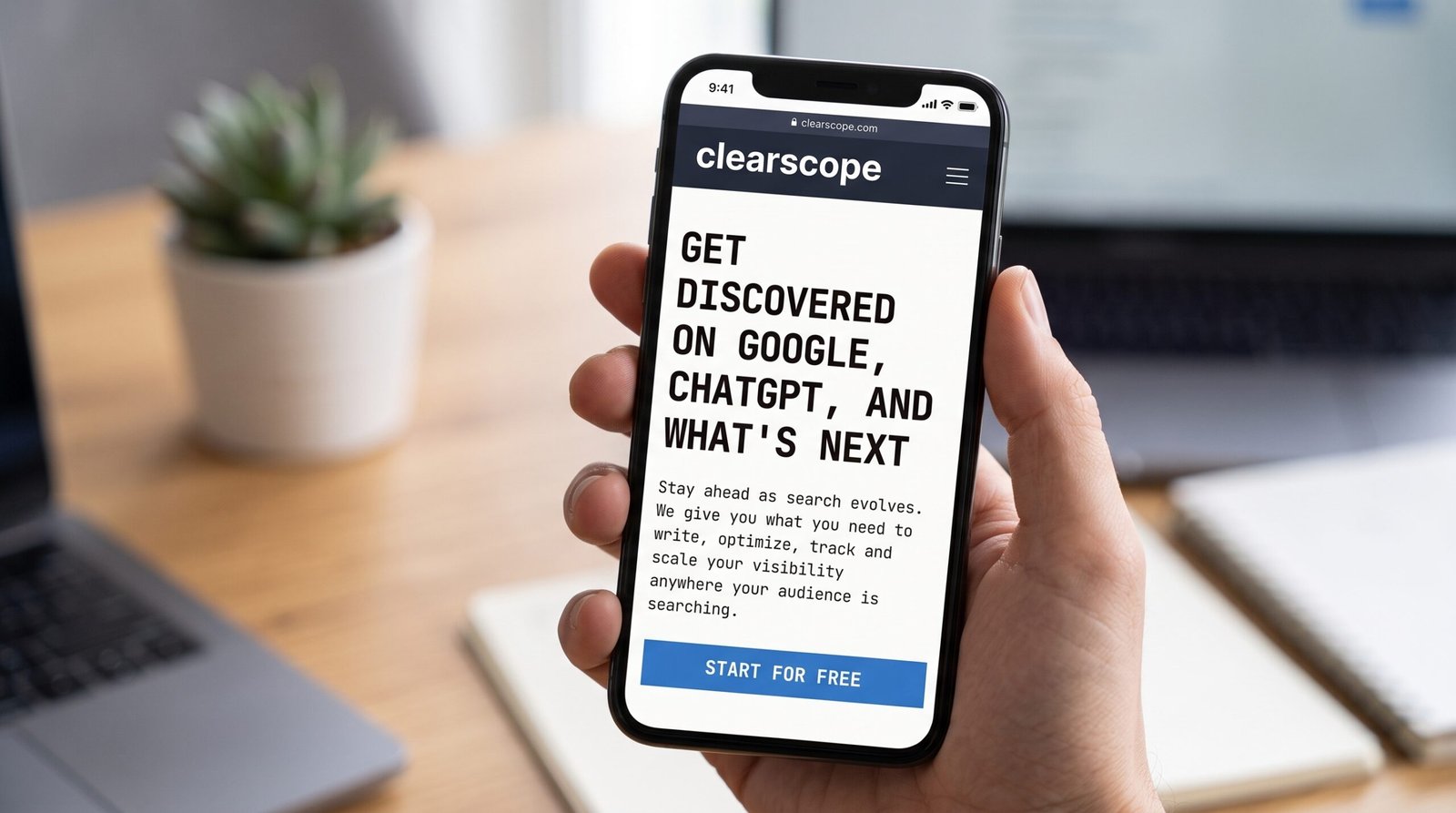 Clearscope review: hand holding a smartphone showing the Clearscope page Get Discovered on Google, ChatGPT and more